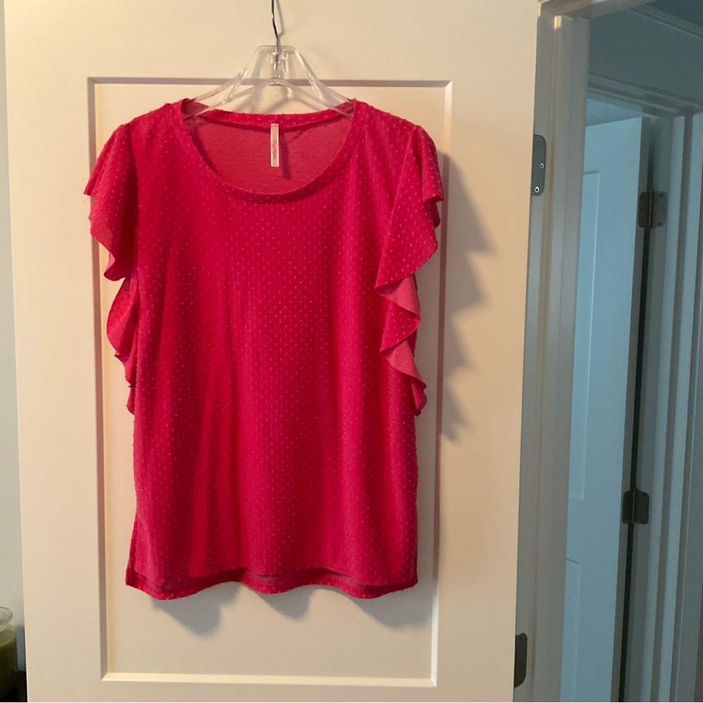 Pink dotted Swiss blouse with short sleeves.